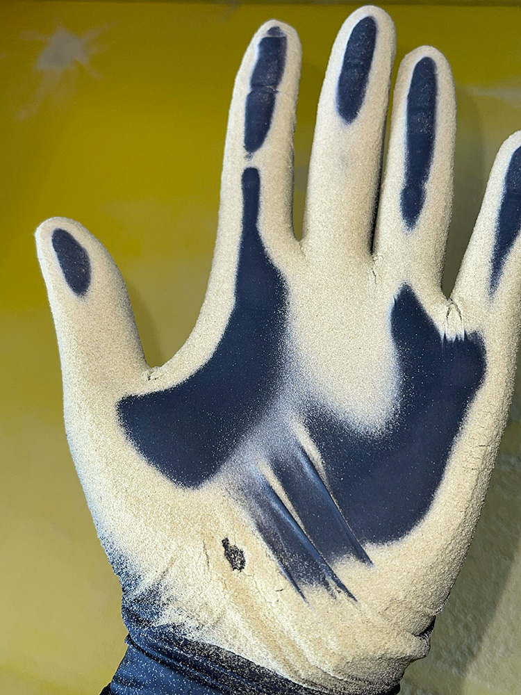 Static sifted cannabis trichomes on a glove